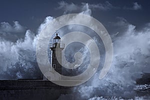 Big wave over old lighthouse