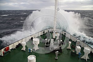 Big wave rolling over the ship