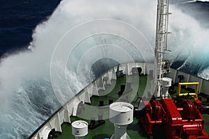 Big wave rolling over the snout of the ship