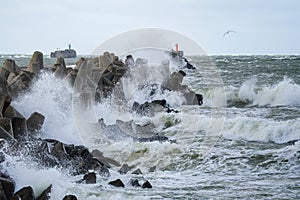 Big waves breaking on breakwater during storm in baltic sea