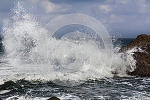 Big waves breaking on shore - wave splashing on rock