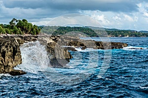 Big waves breaking and splashing on the rocks