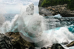 Big waves breaking and splashing on the rocks