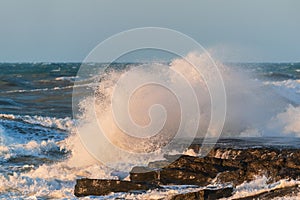 Big waves crash against coastal cliffs. Sea storm