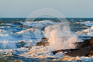Big waves crash against coastal cliffs. Sea storm