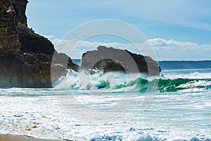 Big waves crash into the rocks of North beach in Nazare city, Portugal