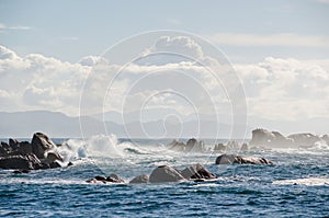 Big waves crashing on rocks coastline