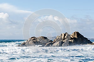 Big waves crashing on rocks coastline