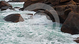 Big waves crashing on a stone beach