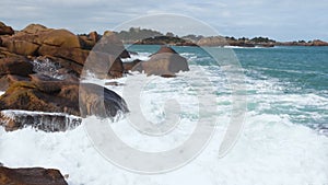 Big waves crashing on a stone beach