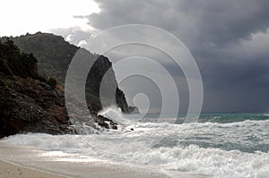 Big waves crushing on curved stone, on stormy weather, big tide. Alanya, Turkey.