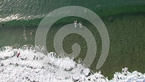 Big Waves rolling from above. Top down 4k drone view on blue turquoise ocean, breaking waves, whitewash