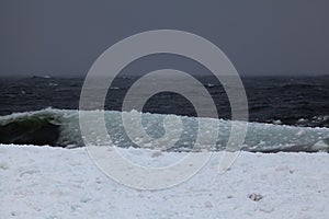 Big waves of slushy ice hit shore of Lake Superior