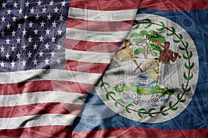 big waving colorful flag of united states of america and national flag of belize on the dollar money background. finance concept