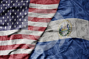 big waving colorful flag of united states of america and national flag of el salvador on the dollar money background. finance