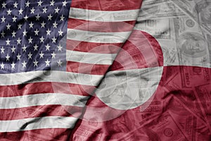 big waving colorful flag of united states of america and national flag of greenland on the dollar money background. finance