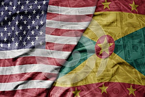 big waving colorful flag of united states of america and national flag of grenada on the dollar money background. finance concept