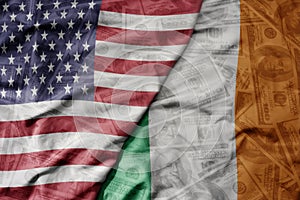 big waving colorful flag of united states of america and national flag of ireland on the dollar money background. finance concept