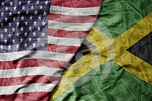 big waving colorful flag of united states of america and national flag of jamaica on the dollar money background. finance concept
