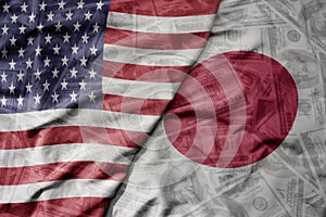 big waving colorful flag of united states of america and national flag of japan on the dollar money background. finance concept
