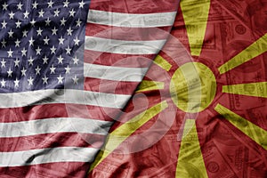 big waving colorful flag of united states of america and national flag of macedonia on the dollar money background. finance