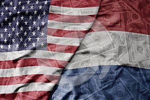 big waving colorful flag of united states of america and national flag of netherlands on the dollar money background. finance