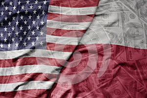 big waving colorful flag of united states of america and national flag of poland on the dollar money background. finance concept