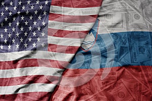 big waving colorful flag of united states of america and national flag of slovenia on the dollar money background. finance concept
