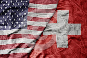 big waving colorful flag of united states of america and national flag of switzerland on the dollar money background. finance