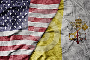 big waving colorful flag of united states of america and national flag of vatican city on the dollar money background. finance