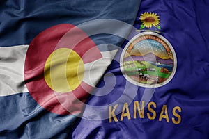 big waving colorful national flag of kansas state and flag of colorado state