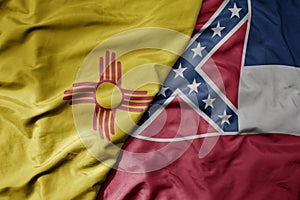 big waving colorful national flag of mississippi state and flag of new mexico state