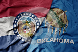 big waving colorful national flag of oklahoma state and flag of missouri state