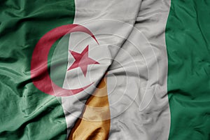 big waving national colorful flag of algeria and national flag of cote divoire