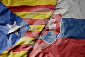 Big waving national colorful flag of catalonia and national flag of slovakia