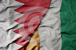 big waving national colorful flag of cote divoire and national flag of bahrain