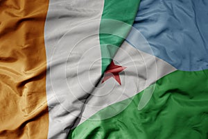 big waving national colorful flag of cote divoire and national flag of djibouti