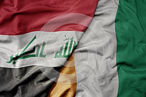 big waving national colorful flag of cote divoire and national flag of iraq