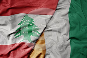 big waving national colorful flag of cote divoire and national flag of lebanon