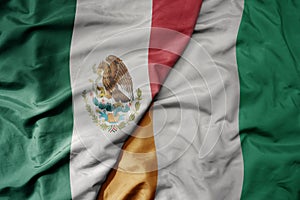 big waving national colorful flag of cote divoire and national flag of mexico