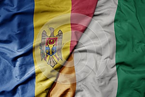 big waving national colorful flag of cote divoire and national flag of moldova