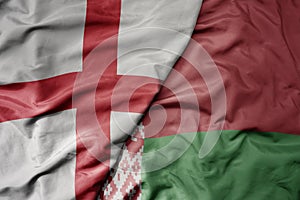 big waving national colorful flag of england and national flag of belarus