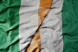 big waving national colorful flag of ireland and national flag of cote divoire