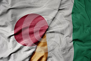 big waving national colorful flag of japan and national flag of cote divoire