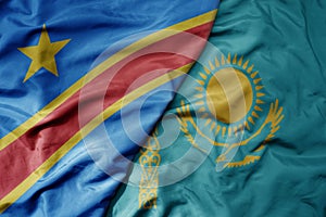 big waving national colorful flag of kazakhstan and national flag of democratic republic of the congo