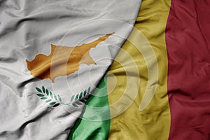 big waving national colorful flag of mali and national flag of cyprus