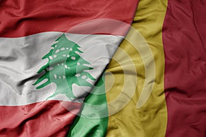 big waving national colorful flag of mali and national flag of lebanon