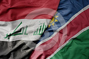 big waving national colorful flag of namibia and national flag of iraq