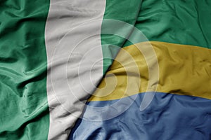 big waving national colorful flag of nigeria and national flag of gabon
