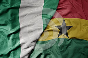 big waving national colorful flag of nigeria and national flag of ghana